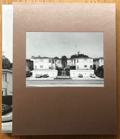The photography book cover of Los Angeles 1976 by Bevan Davies. Hardback in brown with B&W image of suburban houses.