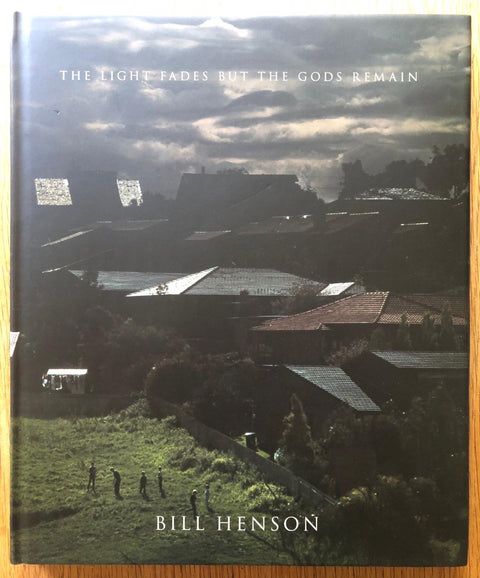 The photography book cover of The Light Fades but the Gods Remain by Bill Henson. Hardback view of rooftops.