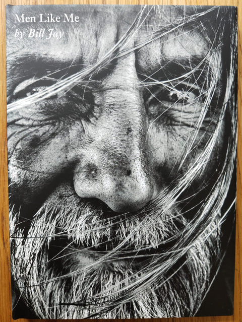 The photography book cover of Men like Me by Bill Jay. Hardback in black and white with close up image of a bearded man.