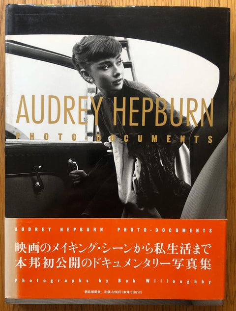 The photography book cover of Audrey Hepburn: Photo Documents by Bob Willoughby. Hardback with image of Audrey Hepburn getting into a car. Signed.
