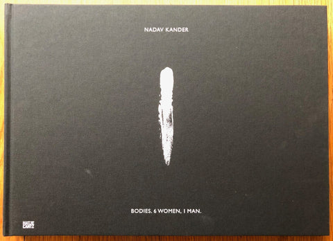 The photography book cover of Bodies 6 Women 1 Man by Nadav Kander. Hardback in black with white text.