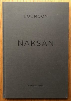 The photography book cover of Naksan by Boomoon. Hardback in grey.