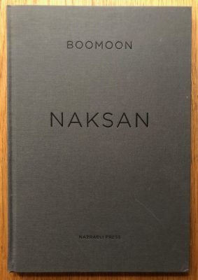 The photography book cover of Naksan by Boomoon. Hardback in grey.