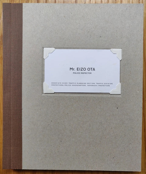 The photography book cover of Mr. EIZO OTA by Brad Zellar. Hardback in brown.
