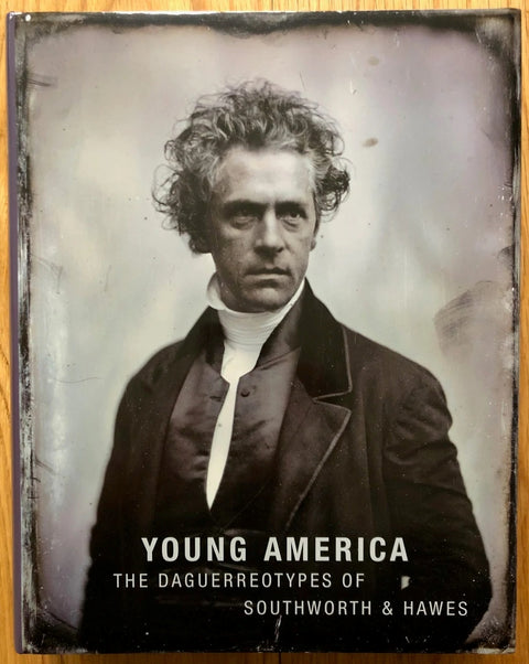 The photography book cover of Young America - The Daguerreotypes of Southworth & Hawes by Brian Wallis and Grant B Romer. Hardback in black and white with a man in a suit on the cover.