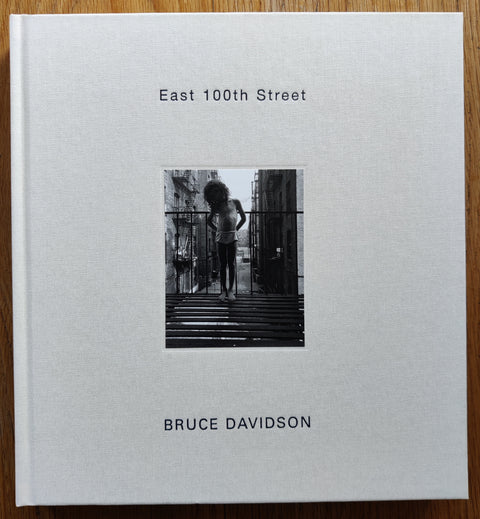 The photography book cover of East 100th Street by Bruce Davidson. In hardcover white.