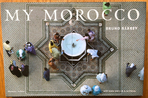 The photography book cover of My Morocco by Bruno Barbey. Hardback with aerial view of people surrounding a water bath.