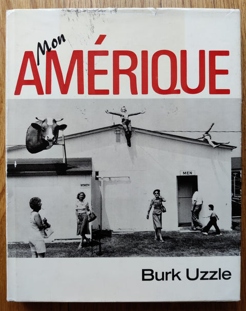 The photography book cover of Mon Amerique by Burk Uzzle. Hardback in black and white with red "Amerique".