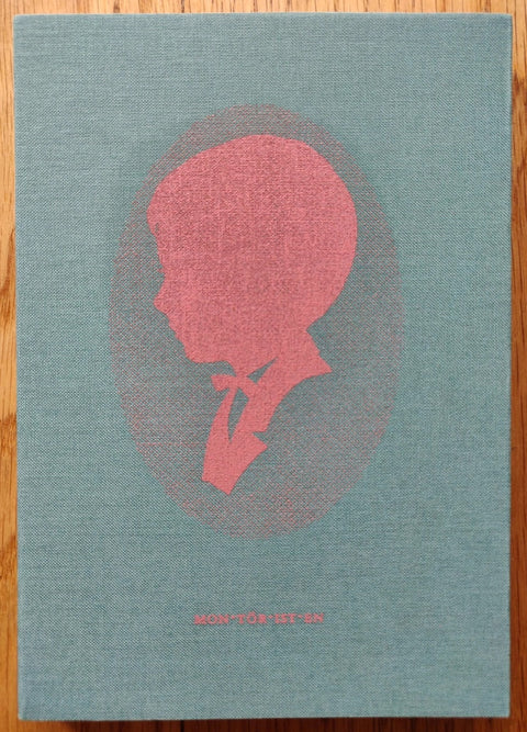 The photography book cover of Montöristen by Carl-Mikael Strom. Hardback in blue/green with a red head in the middle.