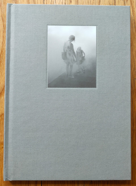 The photography book cover of Turistica by Carlo Rusca. Hardback in light grey. 