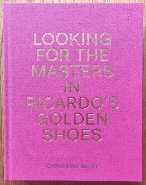 The photography book cover of Looking for the Master's in Ricardo's Golden shoes. Hardback in hot pink with golden title.