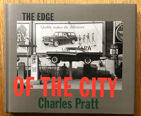 The photography book cover of The Edge of the City by Charles Pratt. Hardback in dark grey with black red and green title.