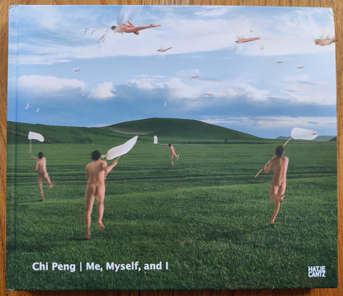 The photography book cover of Me, Myself, and I by Chi Peng. Hardback with image of lots of naked people running with a net in a green field. Signed.