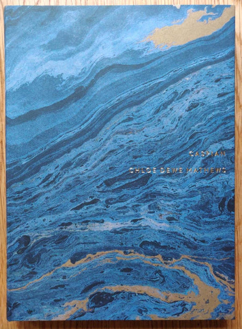 The photography book cover of Caspian: The Elements. Hardback with blue sea-like cover.