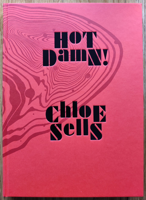 The photobook cover of HOT DAMN! by Chloe Sells. In hardcover red.