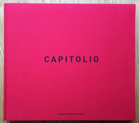 The photography book cover of Capitolio by Christopher Anderson. Hardback in red with centered title.
