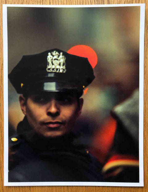 The print from COP by Christopher Anderson. Hardback book with signed print of a cop loosely laid inside.