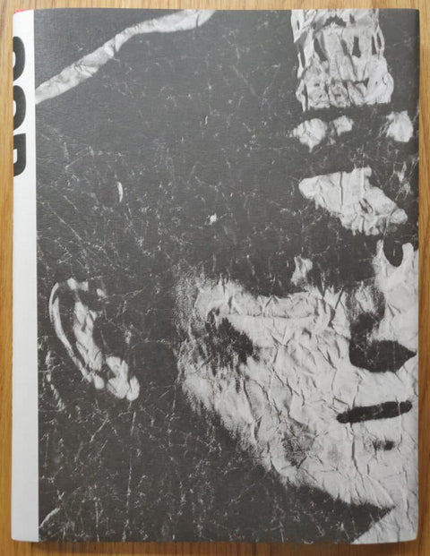 The photography book cover of COP by Christopher Anderson. Hardback with crumpled image of a policeman on the cover.