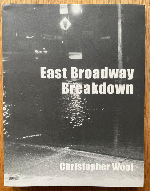 The photography book cover of East Broadway Breakdown by Christopher Wool. Paperback in black and white.