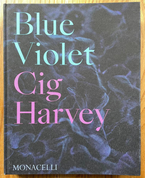 The photography book cover of Blue Violet by Cig Harvey. Hardback in purple with blue and pink title/author. Signed.