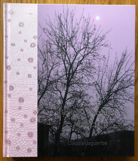 The photography book cover of Beijing Overshoot by Claudia Jaguaribe. Hardback in pink with trees on the cover.