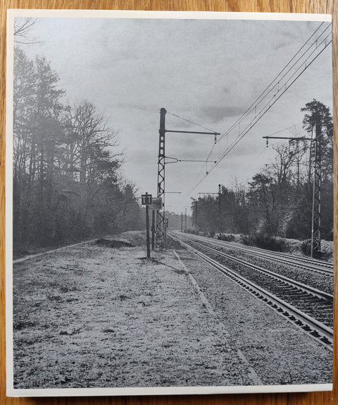 The photography book cover of La Halte by Claudio Silvano. Paperback with B&W image of train tracks on the cover. Signed.