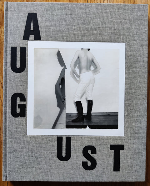 The photography book cover of August by Collier Shorr. In hardcover grey.