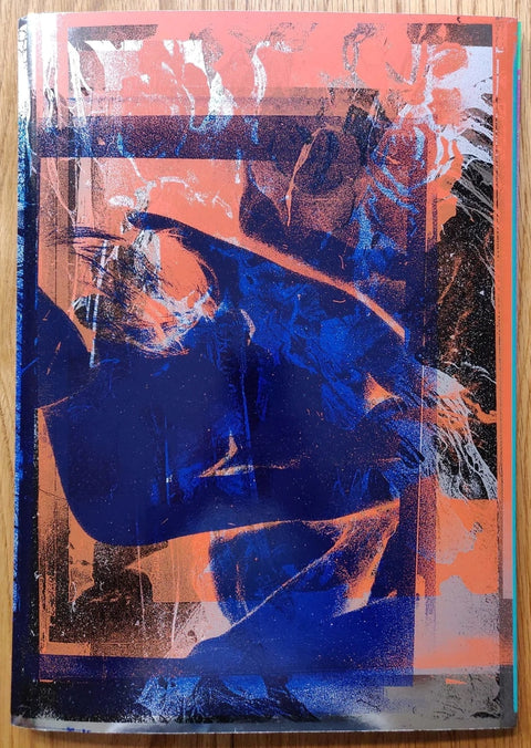 The photography book cover of Inversion by Daisuke Yokota. Paperback in orange and blue.