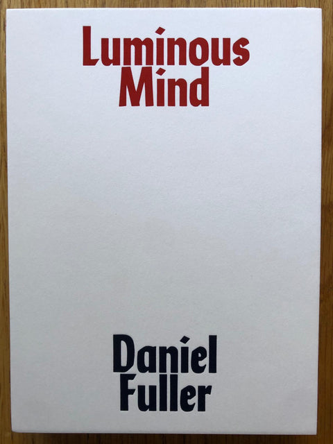 The photography book cover of Luminous Mind by Daniel Fuller. Hardback in white with red title and black author. Signed.