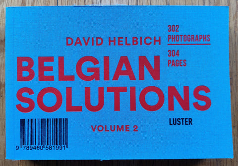 The photography book cover of Belgian Solutions (Volume 2) by David Helbich. Paperback in blue with red text.