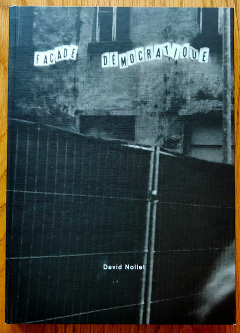 The photography book cover of Facade Democratique by David Nollet. Hardback in black and white.