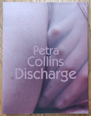 The photography book cover of Discharge by Petra Collins. Paperback with body close up image on cover.