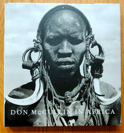 The photography book cover of Don McCullin in Africa. Hardback with cover image of an African tribesman looking into the camera. Signed.