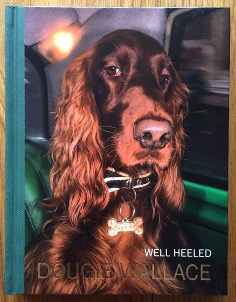 The photography book cover of Well Heeled by Dougie Wallace. Hardback with a photo of a brown dog on the front.