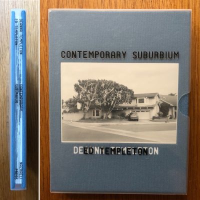 The photography book cover of Contemporary Suburbium by Ed and Deanna Templeton. Hardback blue cover in case.