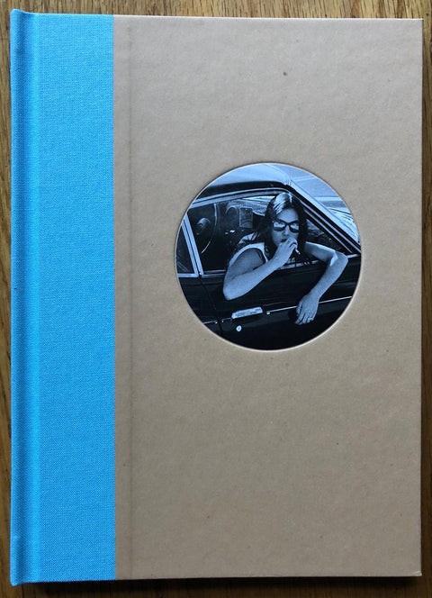 The photography book cover of Auto-Hypnosis by Ed Templeton. Hardback with bright blue binding and image of a woman smoking a cig out of a car window. Signed.