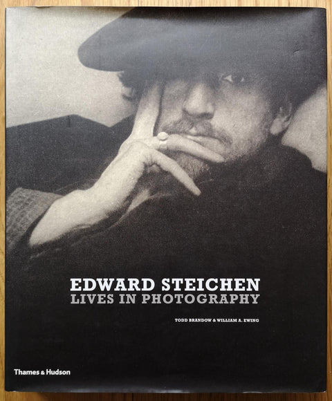 The photography book cover of Lives in Photography by Edward Steichen. In dust jacketed hardcover black.