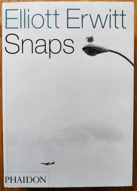 The photobook cover of Snaps by Elliott Erwitt. In softcover white.