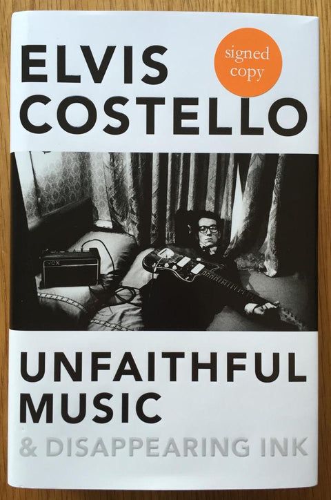 The book cover of Unfaithful music and disappearing ink by Elvis Costello. In dust jacketed hardcover black.