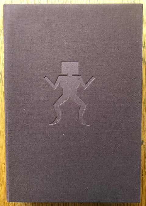 The photography book cover of Anrakuji by Emi Anrakuji. Hardback in brown with a person-like figure on the cover.