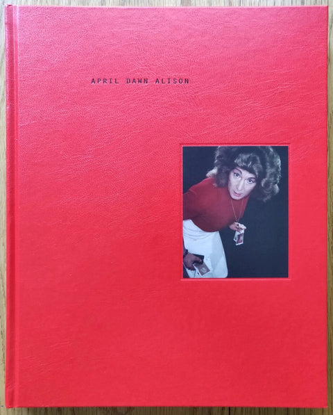 The photography book cover of April Dawn Alison by Erin O'Toole. Hardback in red.