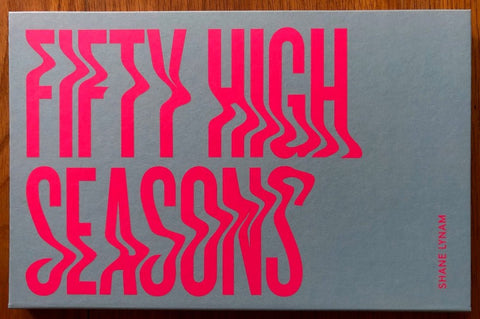 The photography book cover of Fifty High Seasons by Shane Lynam. Hardback with large pink title.