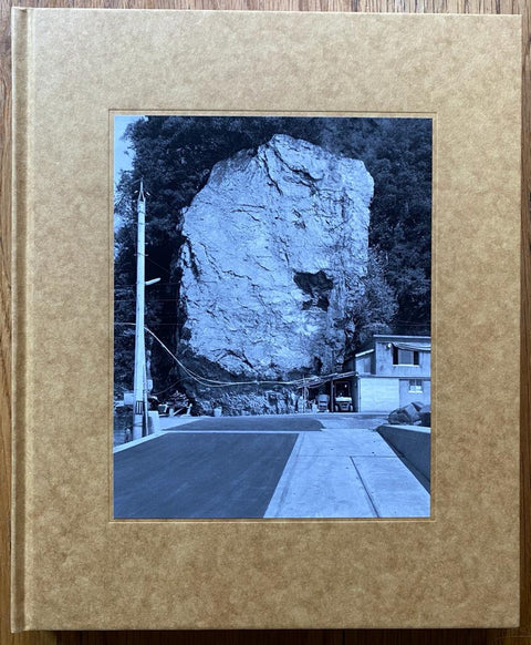 The photography book cover of Ehime by Gerry Johansson. Hardback in dappled brown with B&W image of a large rock. Signed.