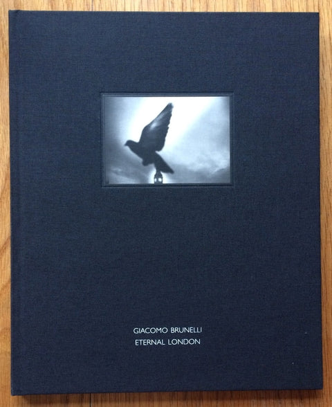 The photography book cover of Eternal London by Giacomo Brunelli. Hardback in dark blue with a small photo of a bird.