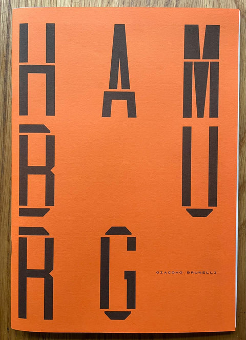 The photography book cover of Hamburg by Giacomo Brunelli. Paperback in orange.