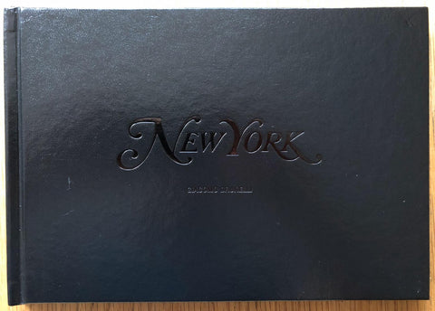 The photobook cover of New York by Giacomo Brunelli. Hardback in black, glossy centred title. Signed.