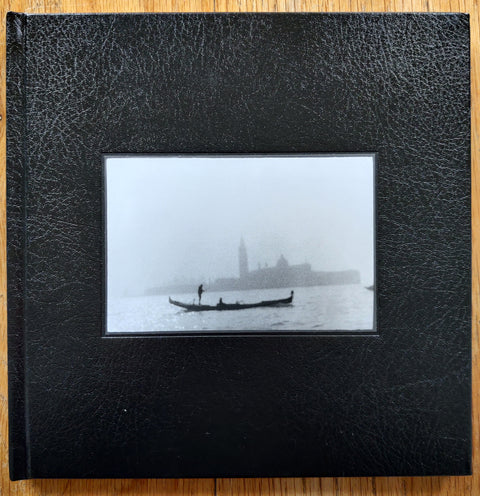 The photobook cover of Venice by Giacomo Brunelli. In hardcover black. Signed.