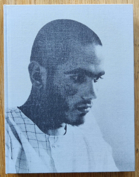 The photography book cover of One Second of Light by Giles Duley. Hardback with a man on the cover.