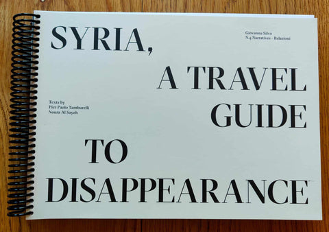 The photography book cover of Syria, A Travel Guide to Disappearance by Giovanna Silva. Paperback in white with spiral black binding.