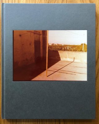 The photography book cover of Tra l'altro, 1976-81 by Guido Guidi. Hardback in grey. Signed.